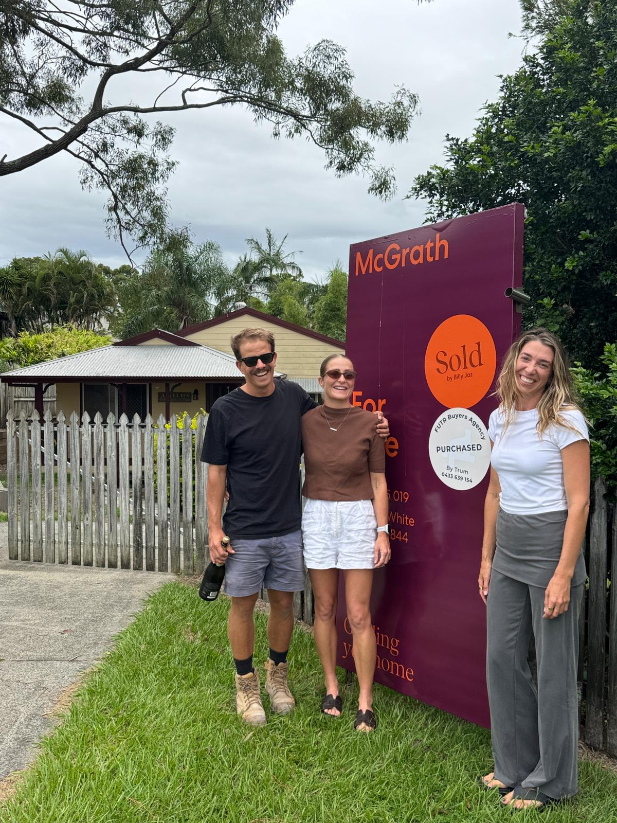 Michael & Em in front of their new home