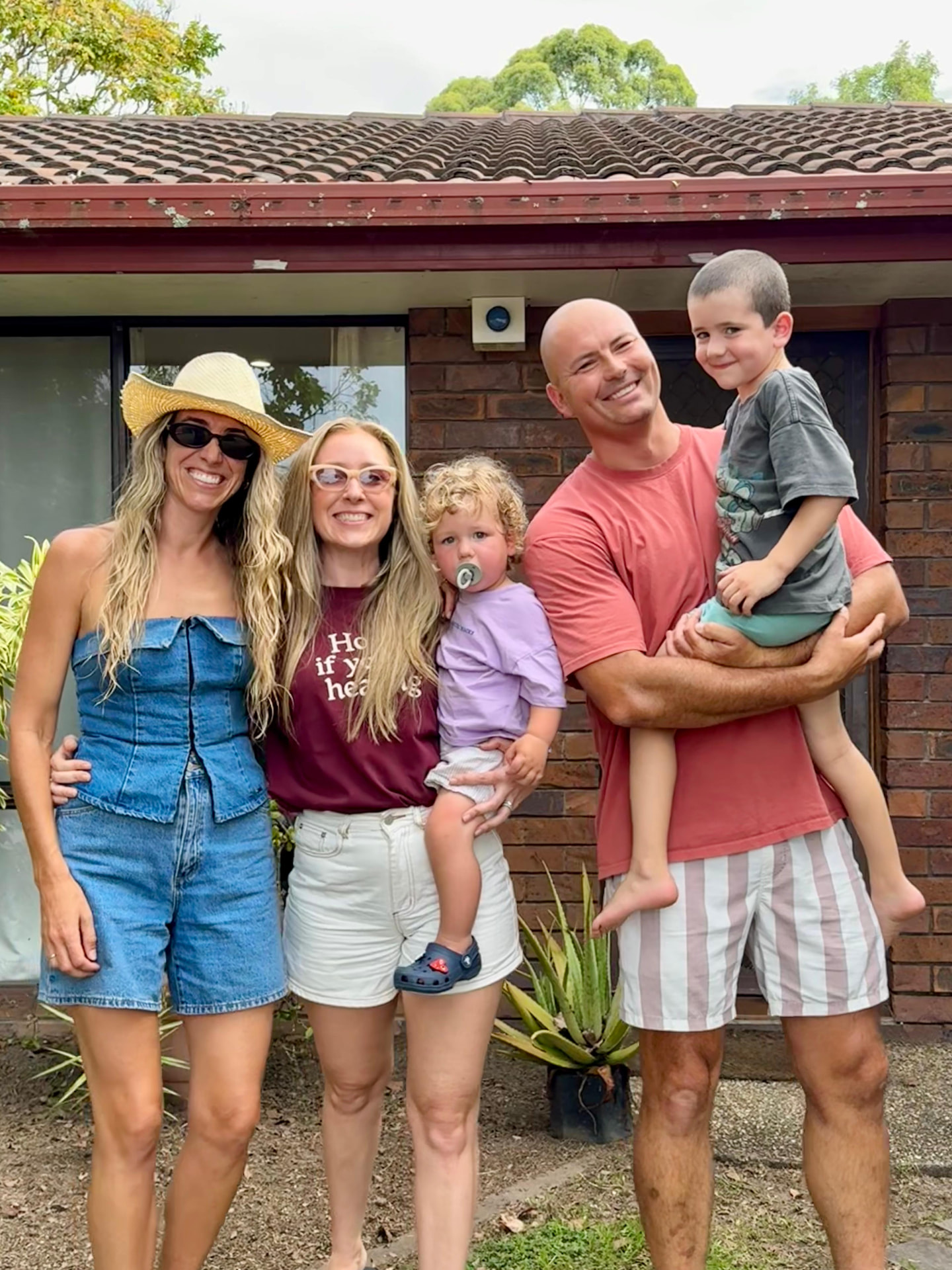 Alana & Matt in front of their new home